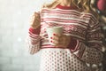 Young beautiful woman drinking cup of coffee blurred winter snow tree background. Royalty Free Stock Photo