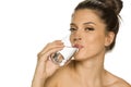 Young beautiful woman drinks water from the glass Royalty Free Stock Photo