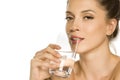 Young beautiful woman drinks water from the glass Royalty Free Stock Photo