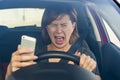 Beautiful woman driving car while texting using mobile phone distracted Royalty Free Stock Photo