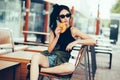 Young beautiful woman eating burger and enjoying while sitting outdoor. Fastfood Unhealthy Lifestyle Fashion Food concepts Royalty Free Stock Photo
