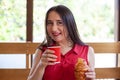 Young beautiful woman eating croissant and drinking coffee Royalty Free Stock Photo