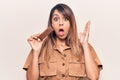 Young beautiful woman eating energy protein bar scared and amazed with open mouth for surprise, disbelief face Royalty Free Stock Photo