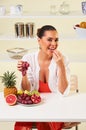 Young beautiful woman eating grapes from a fruit bowl Royalty Free Stock Photo