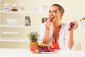 Young beautiful woman eating grapes from a fruit bowl Royalty Free Stock Photo