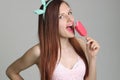 Young beautiful woman eats icecream in studio