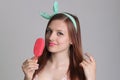 Young beautiful woman eats icecream in studio