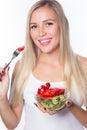 Young beautiful woman eats vegetable salad. Healthy eating. To be in shape. Royalty Free Stock Photo