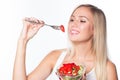 Young beautiful woman eats vegetable salad. Healthy eating. To be in shape. Royalty Free Stock Photo