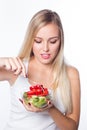 Young beautiful woman eats vegetable salad. Healthy eating. To be in shape. Royalty Free Stock Photo