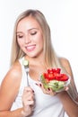 Young beautiful woman eats vegetable salad. Healthy eating. To be in shape. Royalty Free Stock Photo