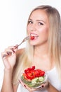 Young beautiful woman eats vegetable salad. Healthy eating. To be in shape. Royalty Free Stock Photo