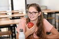 Young beautiful woman enjoying eating an apple at school.Student going to school. Education concept Royalty Free Stock Photo