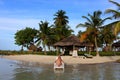 Young beautiful woman enjoying her time and resting close to the sea in the private beach of Yandup Island lodge in Panama. Royalty Free Stock Photo