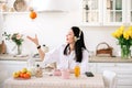 Young beautiful woman enjoying music and coffee while breakfast in kitchen. Royalty Free Stock Photo