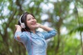 Young beautiful woman enjoying music in the garden listening to music with headphones Royalty Free Stock Photo