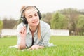 Young beautiful woman enjoying music outdoors on headphones Royalty Free Stock Photo