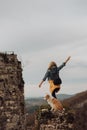 Young beautiful woman enjoying the view with her dog during hiking trip in the mountain Royalty Free Stock Photo