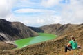 Young beautiful woman enjoys the view at Laguna Verde lake in Narino, Colombia