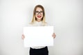 Young beautiful woman in eyeglasses holding blank sheet of paper isolated white background space for text Royalty Free Stock Photo
