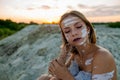 Beautiful Woman With Eyes Closed And White Clay Facial Mask On Face And Body In Nature. Royalty Free Stock Photo