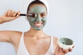 Young beautiful woman in face mask of therapeutic blue mud. Spa Royalty Free Stock Photo