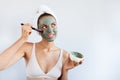 Young beautiful woman in face mask of therapeutic blue mud. Spa