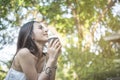 Young beautiful woman feeling happy and powerful while drinking coffee at the park in the morning Royalty Free Stock Photo