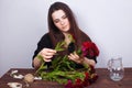 Young beautiful woman florist making bouquet of carnations. Flor Royalty Free Stock Photo