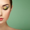 Young beautiful woman with flower makeup eyes Royalty Free Stock Photo