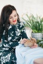 Young beautiful woman with fluffy rabbit  indoors on Easter day. Happy easter and festive holiday Royalty Free Stock Photo