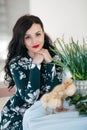 Young beautiful woman with fluffy rabbit indoors on Easter day. Happy easter and festive holiday Royalty Free Stock Photo
