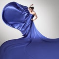 Young beautiful woman in fluttering blue dress. Royalty Free Stock Photo