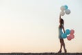 beautiful woman with flying multicolored balloons Royalty Free Stock Photo