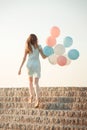 beautiful woman with flying multicolored balloons Royalty Free Stock Photo