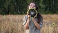 Young beautiful woman funny posing with sunflower on a hot summer day Royalty Free Stock Photo