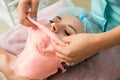 Young beautiful woman get alginate modeling mask to the face in a beauty salon