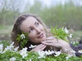 Young beautiful woman on a glade of blossoming snowdrops Royalty Free Stock Photo