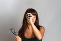 Young beautiful woman with glasses and a roll of magazine in her hands. She holds the magazine in the form of a telescope. Copy Royalty Free Stock Photo