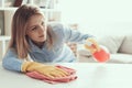 Young Beautiful Woman in Gloves Cleaning House