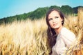 Young beautiful woman in golden wheat field Royalty Free Stock Photo