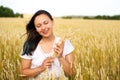 Young beautiful woman in golden wheat field. concept of summer, freedom, warmth, harvest, agriculture Royalty Free Stock Photo