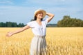 Young beautiful woman in golden wheat field. concept of summer, freedom, warmth, harvest, agriculture Royalty Free Stock Photo