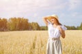 Young beautiful woman in golden wheat field. concept of summer, freedom, warmth, harvest, agriculture Royalty Free Stock Photo