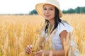 Young beautiful woman in golden wheat field. concept of summer, freedom, warmth, harvest, agriculture Royalty Free Stock Photo