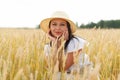 Young beautiful woman in golden wheat field. concept of summer, freedom, warmth, harvest, agriculture Royalty Free Stock Photo