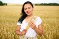 Young beautiful woman in golden wheat field. concept of summer, freedom, warmth, harvest, agriculture Royalty Free Stock Photo