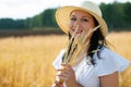 Young beautiful woman in golden wheat field. concept of summer, freedom, warmth, harvest, agriculture Royalty Free Stock Photo