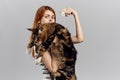 Young beautiful woman on a gray background holds a cat, maine coon Royalty Free Stock Photo