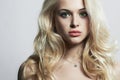 Young beautiful woman. Green eyes & Pink lips. Blond girl. Curly hairstyle